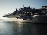 gray warship on body of water