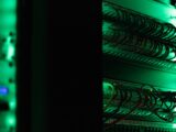 a rack of electronic equipment in a dark room